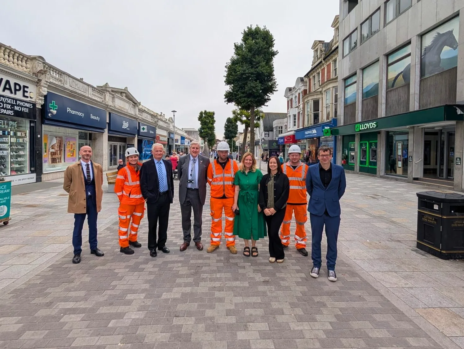 Councillors, council staff and contractors on the repaved stretch of Terminus Road outside Boots and Lloyds